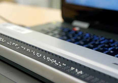 Das Bild zeigt eine Braillezeile auf einer Computertastatur.