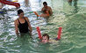 Ein Schüler setzt die Technikanweisungen der Trainerin zum Brustschwimmen im Nichtschwimmerbecken um.